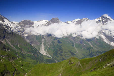 Grossglockner high mountains with clouds and frosen snowの写真素材