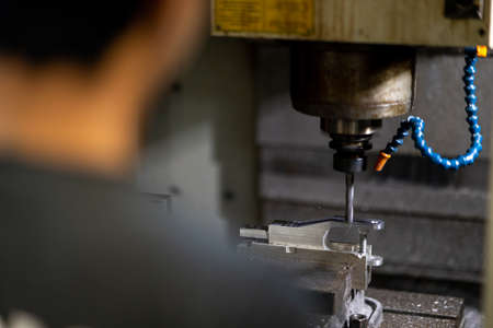 milling cnc machine at metal work industry with people foreground . Multitool precision machining.の写真素材