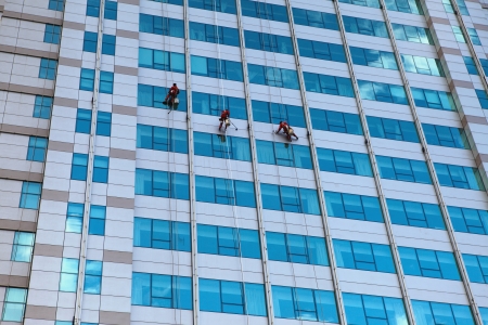 Workers washing windows の写真素材