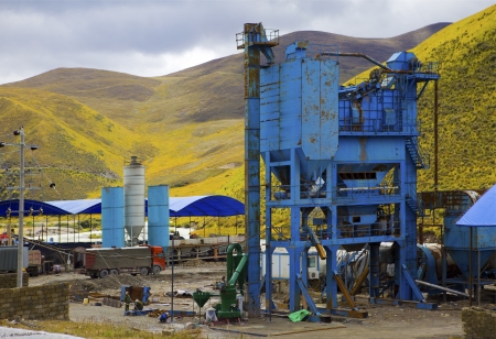 Gravel pit and Belt conveyors in summer in front of cloudy blue sky after storm の写真素材