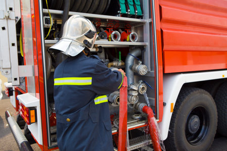 Firefighters getting equipment from truck
