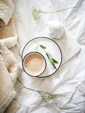 Cup of coffee on the bed. Cozy morning concept.の写真素材