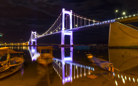 Da Nang, Vietnam - June 24th, 2015: Architecture Thuan Phuoc bridge cable stayed Reflected on the river with lights radiating rays and boats floating night scenes more beautiful Makes in Da Nang, Vietnamのeditorial素材