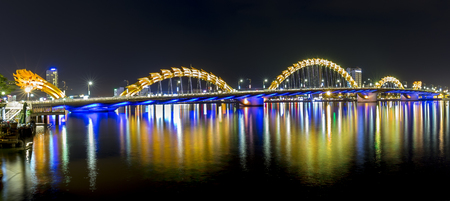Da Nang, Vietnam - 25th June, 2015: architectural beauty of the Dragon Bridge Reflected lights shimmering on the river at night create the beauty of the resort city of Da Nang, Vietnamのeditorial素材