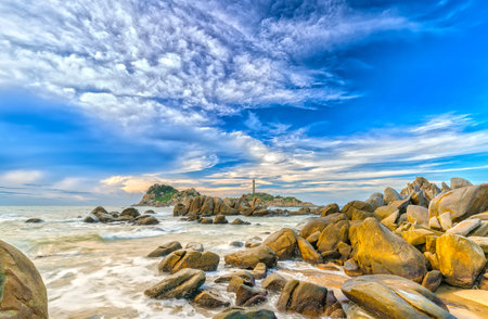 Sunny early in the century-old lighthouse with dramatic clouds and Reefs to Attract tourists to visitの写真素材