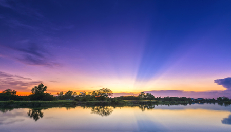 Rays of sunset the sun goes along river khi down to the horizon shining the sunshine Into the dramatic sky. This rare moment is admired in the sky at the end of day.の写真素材