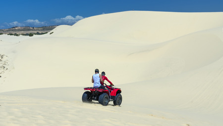 Mui Ne, Vietnam - February 18th, 2017: Travelers are experiencing the thrill of crossing the sand dunes by the off-road vehicle at Mui Ne, Vietnam.のeditorial素材