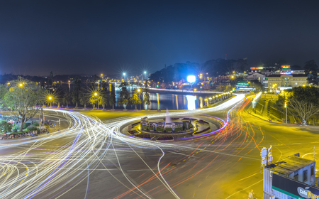 Dalat, Vietnam - March 27th, 2017: Roundabout intersections with lights Dalat night market, creating in streaks of color motorcycle in Da Lat, Vietnamの写真素材