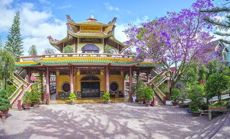 Dalat, Vietnam - March 28th, 2017: The beauty of architecture Jacaranda temple flowers bloom beside expressive peace, Dalat, Vietnamのeditorial素材