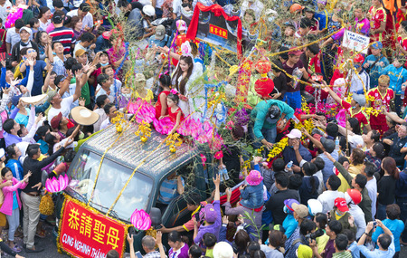 Binh Duong, Vietnam - February 11th, 2017: Chinese Lantern Festival with car flags, girls on the donated money, fortune for visitors as good luck early in the street parade in Binh Duong, Vietnamのeditorial素材