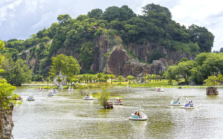 Dong Nai, Vietnam - June 4th, 2017: People relaxing on a swan boat on a spring on a sunny spring morningのeditorial素材