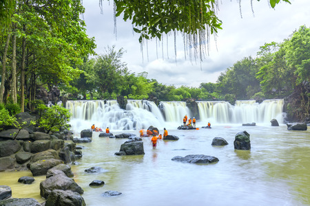 Dong Nai, Vietnam - June 25th, 2017: Beautiful waterfalls in Ecotourism with water flowing smooth as silk attract tourists to visiton a sunny summer day in Dong Nai, Vietnamの写真素材