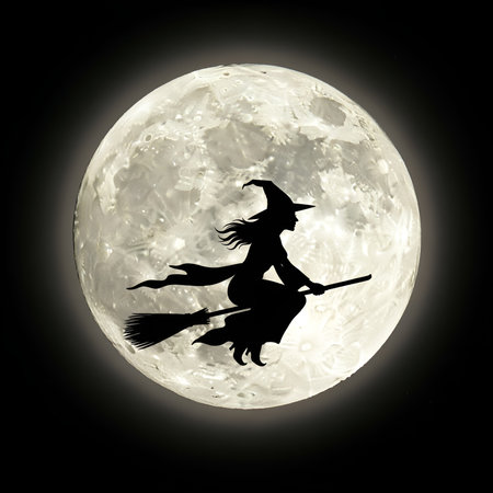 a halloween image of a witch flying on a broomstick in silhouette against a full moon at night.の素材