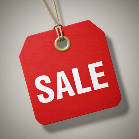 A red sale tag with white text, hanging by a string. Ideal for retail and marketing campaigns.の素材