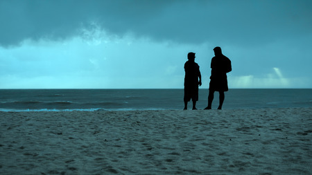 silhouette couple were relaxing on the beachの写真素材
