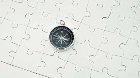 Compass on white puzzleの写真素材