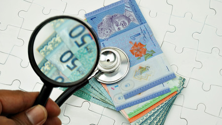 stethoscope, magnifying glass and banknotes, medical online conceptの写真素材