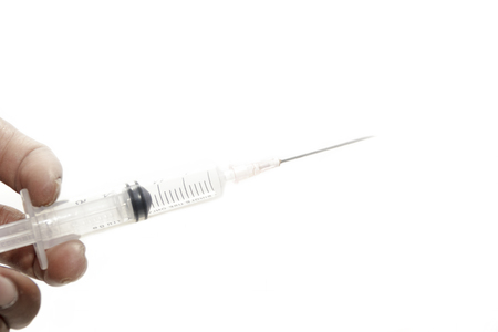 Hands holding medical injections - medical conceptsの写真素材