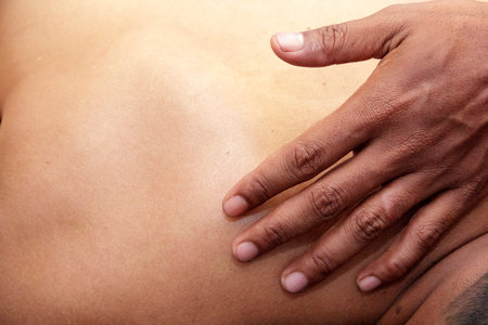 sport massage - men's hands are doing sport massage on the part of the human bodyの写真素材