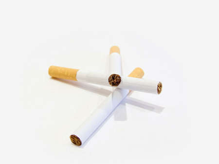 Three cigarettes with the filter on a white backgroundの写真素材