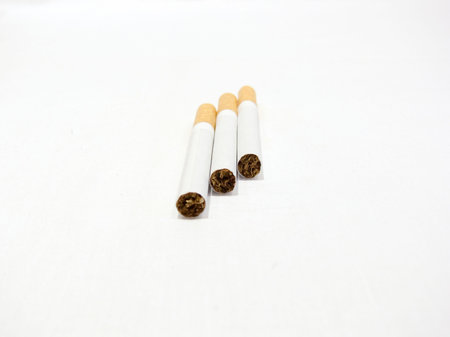 Three cigarettes with the filter on a white backgroundの写真素材
