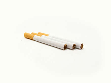 Three cigarettes with the filter on a white backgroundの写真素材