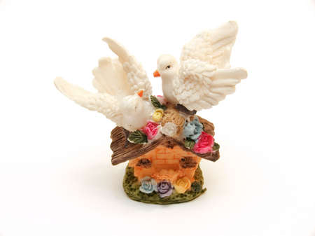 Souvenir as two pigeons on a roof of a small houseの写真素材