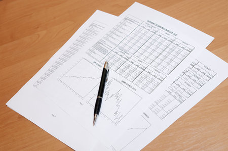 The pen and financial business report with diagrams