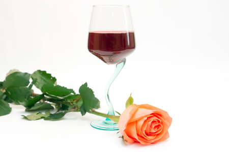 Red wine in a glass and a roseの写真素材