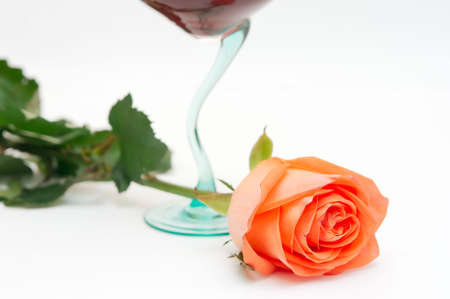 Red wine in a glass and a roseの写真素材