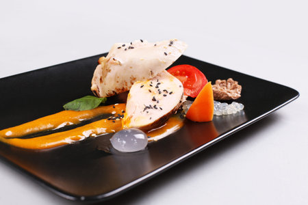 Chicken breast with vegetables on a white plate.の写真素材