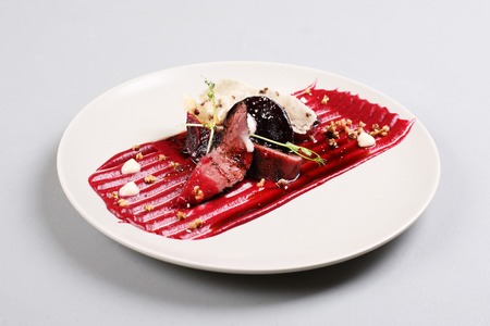 Delicious veal fillet served with sauce, molecular froth and beetrootの写真素材