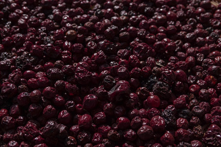 Full-frame background of dried jujube fruits (red dates) with rich dark red texture, traditional...