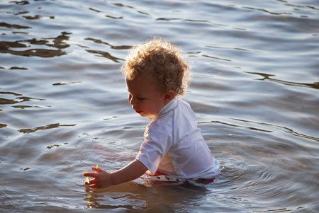 Baby playing in the waterの写真素材