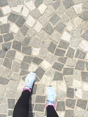 footwear on stoneblock prdestrian backgroundの写真素材