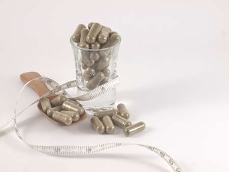 herb in capsule pill for diet on white backgroundの写真素材