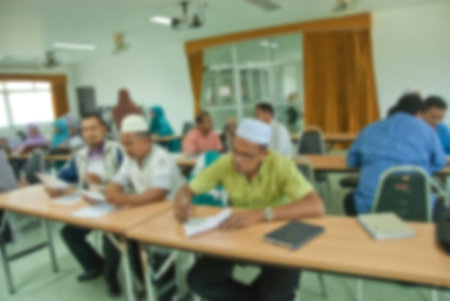 blur image of adult asian muslims in classroom for background