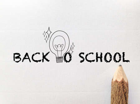 concept idea for back to school wording and light bulb on white note paper with pencilの写真素材