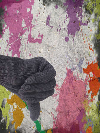 thumb down finger sign for reject symbol on defected concrete panel background or textureの写真素材