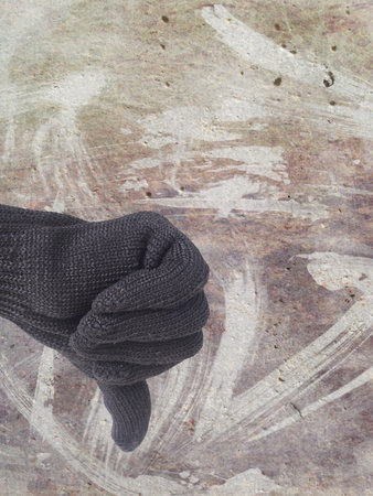 thumb down finger sign for reject symbol on defected concrete panel background or texture