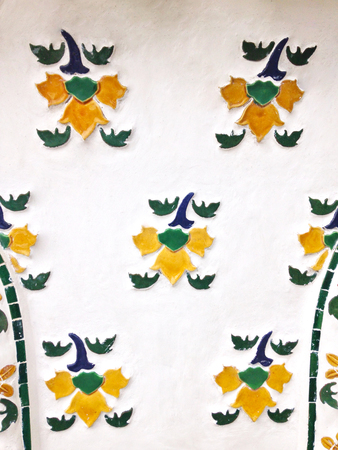 yellow flower mosaic on white cement background or panelの写真素材