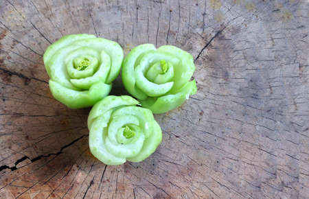 roses from rearrange of cutting lettuce on wooden plate or chopping blockの写真素材