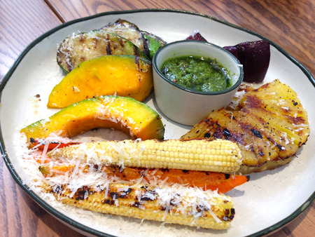 grilled vegetables plate with pesto sauce on white dishの写真素材