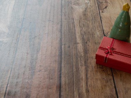 christmas tree and red gift for merry christmas background on wood plank with paper spaceの写真素材