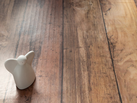 white angel for merry christmas background on wood plank with  paper spaceの写真素材