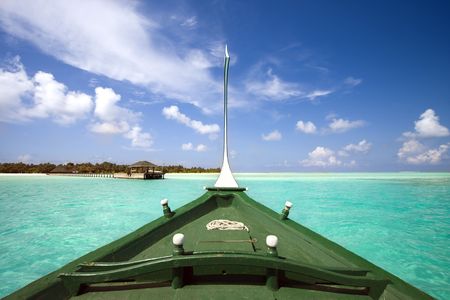 Boat travelling towards tropical islandの写真素材