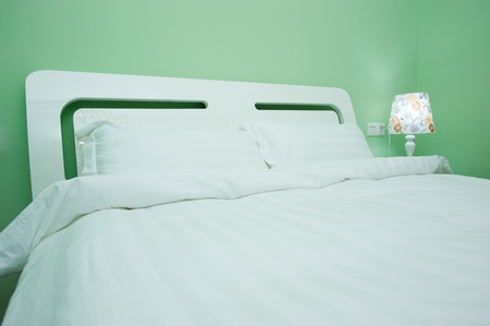 King sized bed in a business hotel room の写真素材