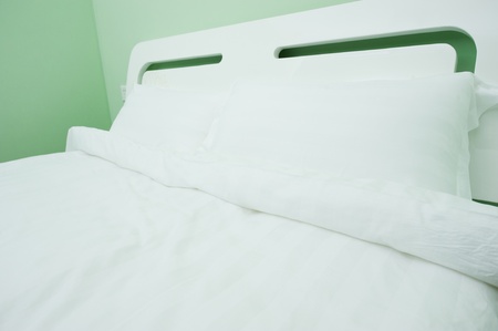 King sized bed in a business hotel room の写真素材