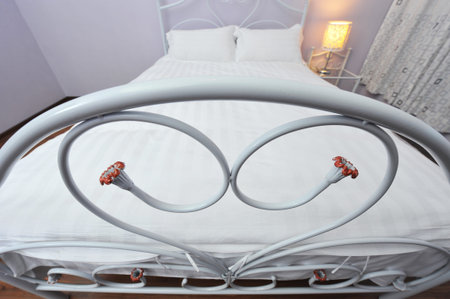 King sized bed with heart shape bedstead.の写真素材