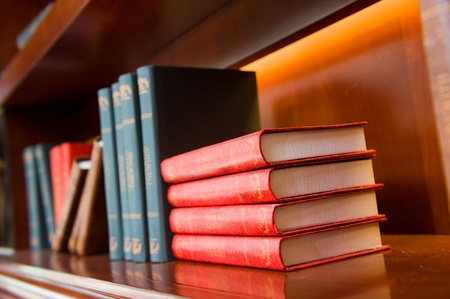 Old hardcover books on a bookshelf.の写真素材